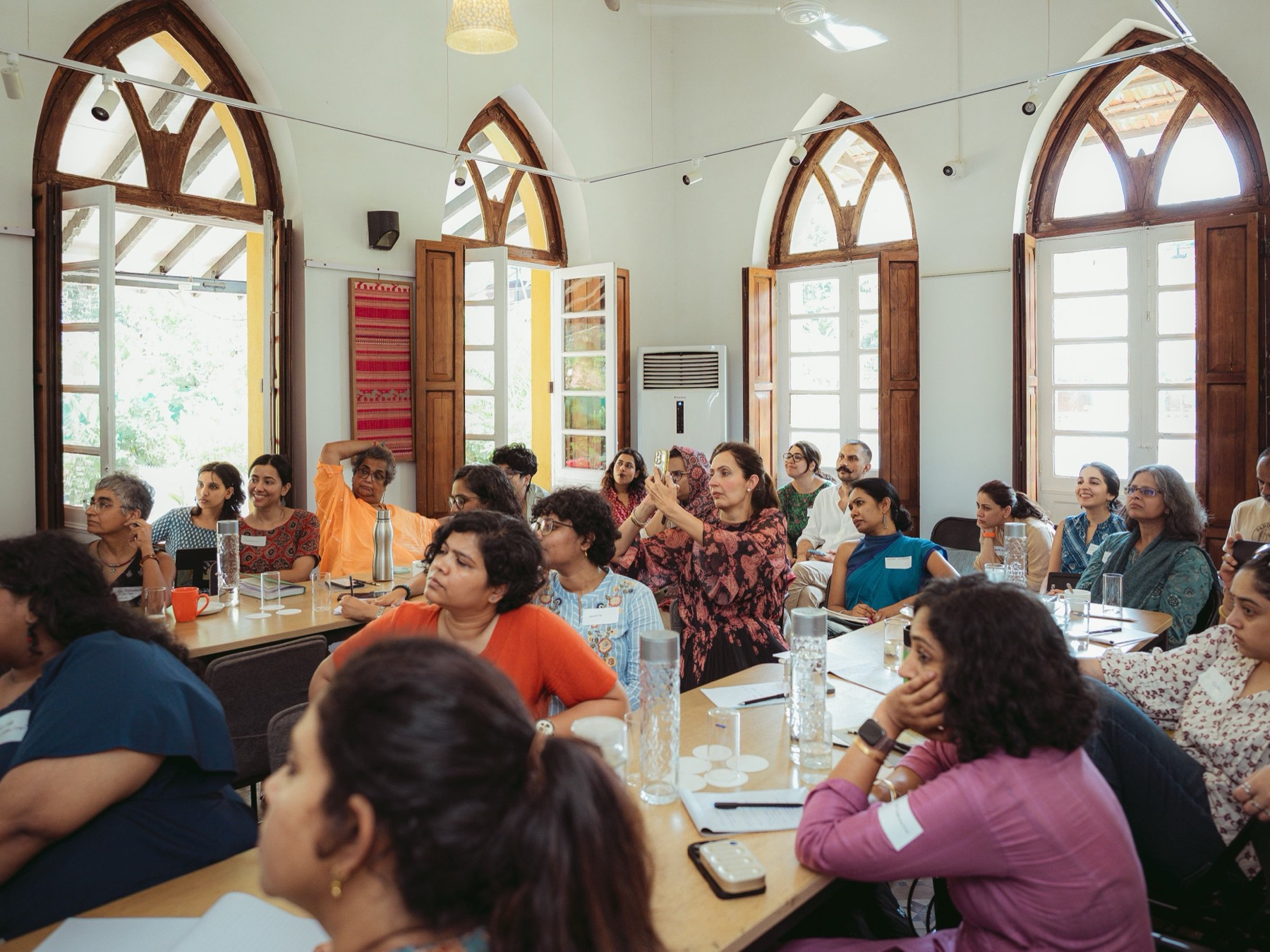 A full room of participants seated around tables at a 10K2Zero convening